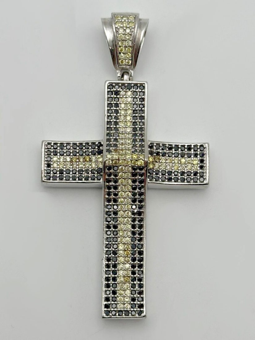 925 SILVER CROSS PENDANT WITH BLACK/YELLOW CUBIC ZIRCONIA 34.4 GRAMS: 925 Silver Cross Pendant with Black/Yellow Cubic Zirconia Condition: Used Material: 925 Sterling Silver Pendant Size: 3.25 inches x 2.75 inches Total Weight: 34.4 grams Stone Info: all Black and Yello