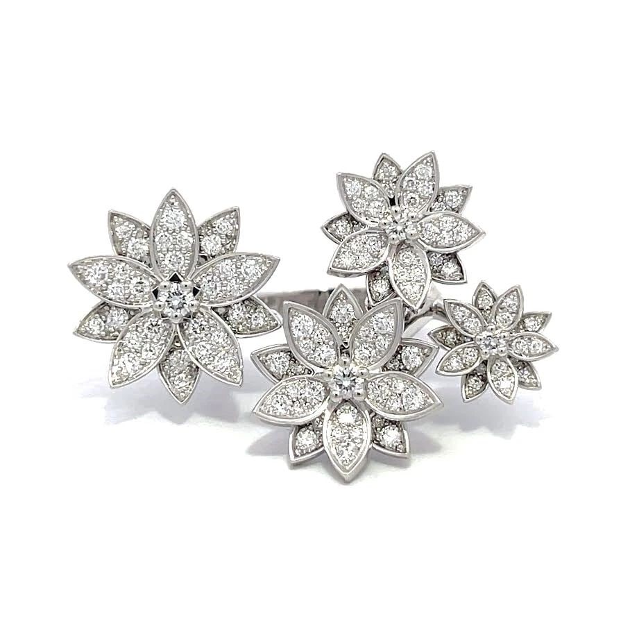 VAN CLEEF & ARPELS RING LOTUS BETWEEN THE FINGER, 4 FLOWERS 18K DIAMONDS: VAN CLEEF & ARPELS RING LOTUS BETWEEN THE FINGER, 4 FLOWERS 18K DIAMONDS VAN CLEEF & ARPELS RING LOTUS BETWEEN THE FINGER, 4 FLOWERS 18K DIAMONDS This is a charming authentic ring by Van Cleef & Arpel