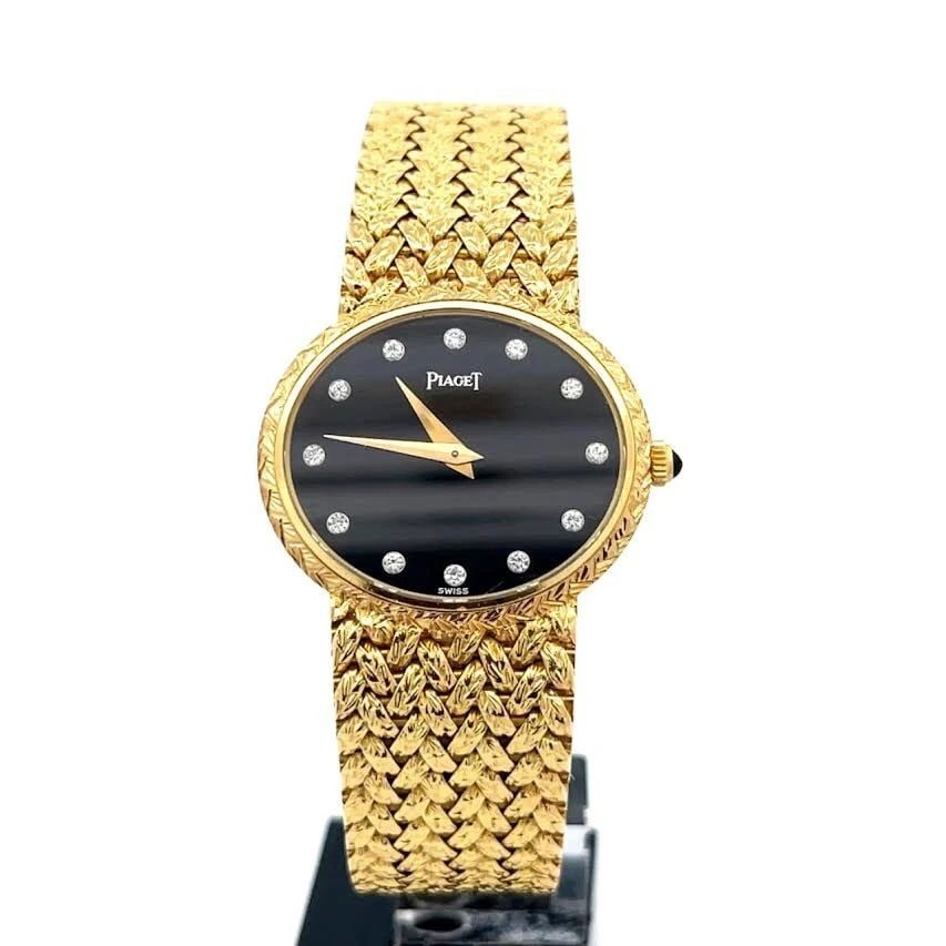 PIAGET 18K GOLD WRISTWATCH DIAMOND DIAL HAND-WIND #9802 D2: PIAGET 18K GOLD WRISTWATCH DIAMOND DIAL HAND-WIND #9802 D2 This beautiful authentic wristwatch is by Piaget, it is manual wind with black face and diamond hour markers and gold tone hands. Sapphire cr