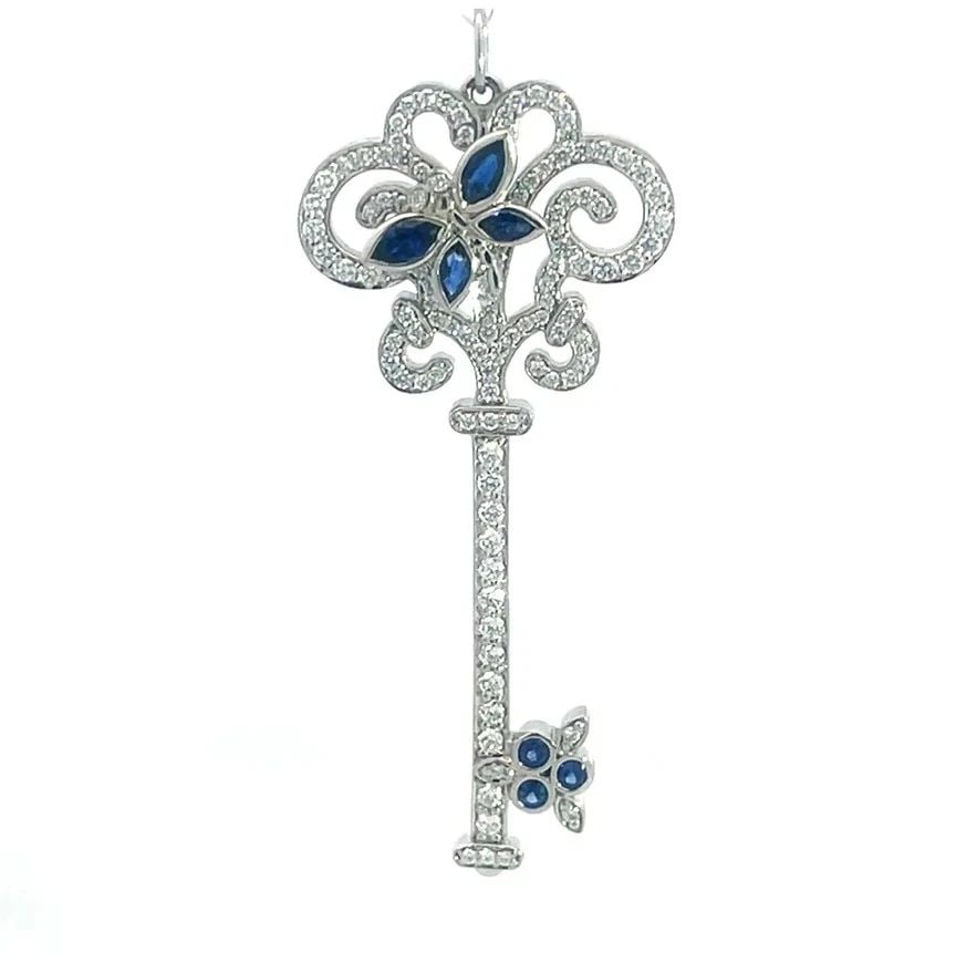 TIFFANY & CO. ENCHANT BUTTERFLY KEY PENDANT DIAMOND SAPPHIRE PLATINUM: TIFFANY & CO. ENCHANT BUTTERFLY KEY PENDANT DIAMOND SAPPHIRE PLATINUM This is a stunning key pendant by Tiffany & Co. from the Enchant Collection. It features a floral top design key fully decorated w