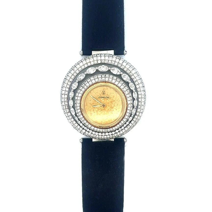 CORUM DIAMOND GOLD WATCH 18K TWO TONE MANUAL WIND FANCY BEZEL SATIN BAND: CORUM DIAMOND GOLD WATCH 18K TWO TONE MANUAL WIND FANCY BEZEL SATIN BAND This gorgeous Corum diamond and gold wristwatch is a vintage timepiece designed for women, featuring a classic 22mm round 18k g