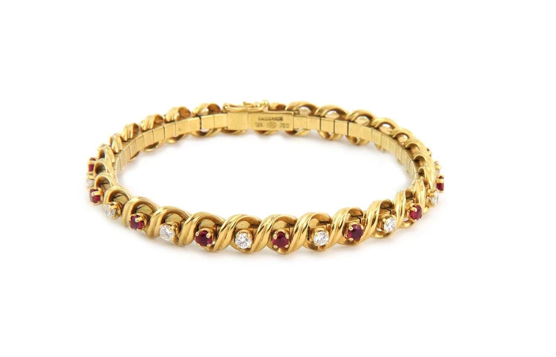 DIAMOND RUBY GOLD BRACELET 18K YELLOW SPIRO LINK SWISS MADE: DIAMOND RUBY GOLD BRACELET 18K YELLOW SPIRO LINK SWISS MADE DIAMOND RUBY GOLD BRACELET 18K YELLOW SPIRO LINK SWISS MADE The Diamond Ruby Gold Bracelet features a luxurious design with a spiral link st