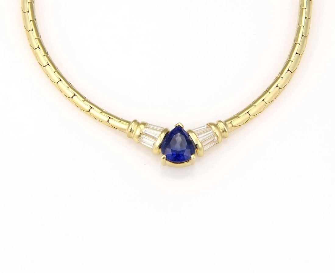 DIAMOND SAPPHIRE GOLD NECKLACE 18K YELLOW PEAR SHAPE CENTERPIECE: DIAMOND SAPPHIRE GOLD NECKLACE 18K YELLOW PEAR SHAPE CENTERPIECE This beautiful gold necklace features a gorgeous pear-shaped centerpiece with a pear shape sapphire gemstone in the center accented wit