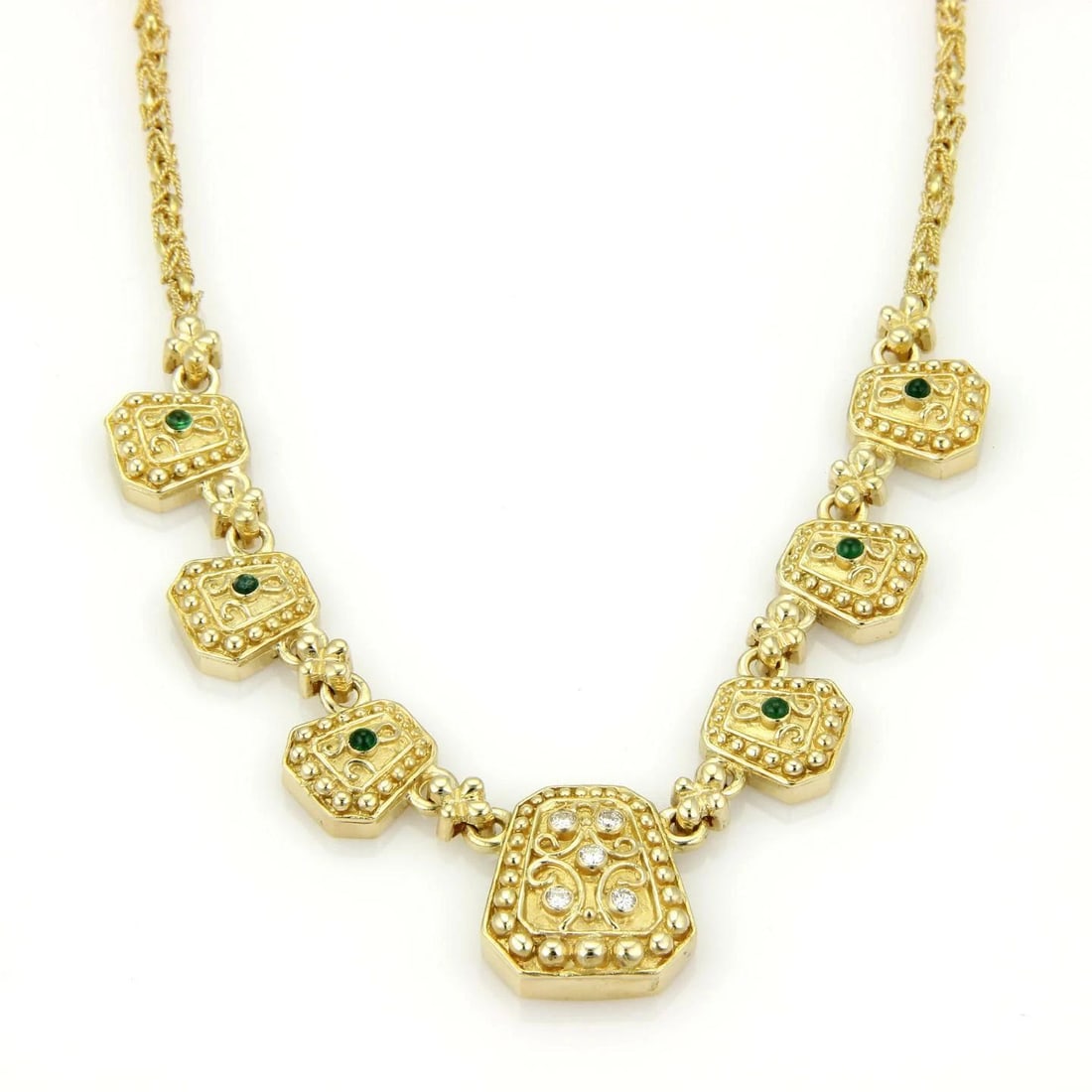 DIAMOND GOLD NECKLACE CABOCHON EMERALD GEOMETRIC SHAPE: DIAMOND GOLD NECKLACE CABOCHON EMERALD GEOMETRIC SHAPE This diamond gold necklace features odd shape large to small motifs decorated with diamonds and emerald. The white diamond set in a yellow gold c