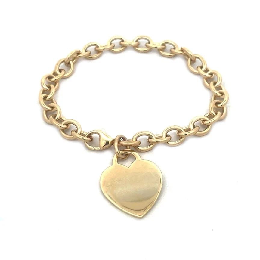 TIFFANY & CO. GOLD BRACELET 18K YELLOW HEART CHARM OVAL CHAIN LINK STYLE: TIFFANY & CO. GOLD BRACELET 18K YELLOW HEART CHARM OVAL CHAIN LINK STYLE TIFFANY & CO. GOLD BRACELET 18K YELLOW HEART CHARM OVAL CHAIN LINK STYLE The product is a vintage Tiffany & Co. gold bracelet f