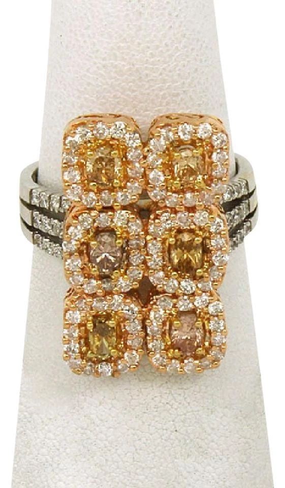 YELLOW & WHITE DIAMOND RING MULTITONE GOLD ESTATE: YELLOW & WHITE DIAMOND RING MULTITONE GOLD ESTATE This Yellow & White Diamond Ring in Multi-Tone Gold is a stunning piece of estate jewelry with an oval-shaped main stone set in a prong setting. The r