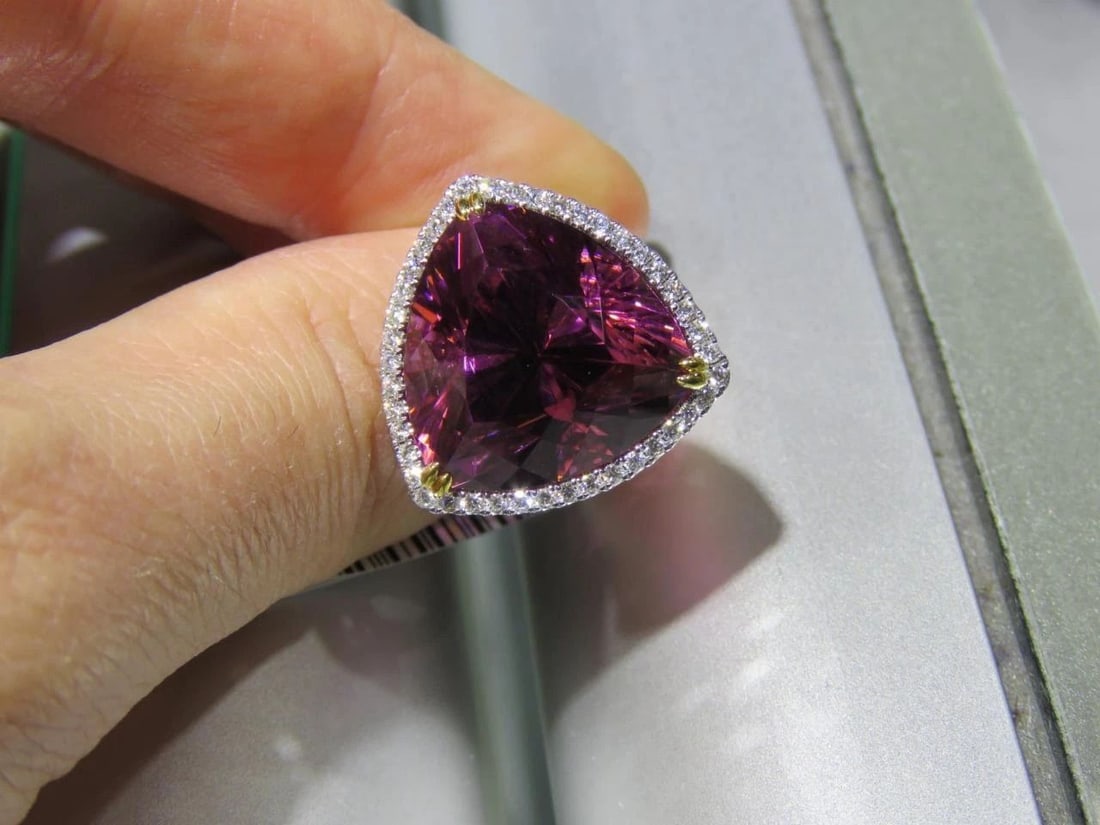 18KT LRG 25CT RUBELITE AND DIAMOND RING: 18KT LRG 25CT RUBELITE AND DIAMOND RING The Following Item we are offering is this Beautiful Rare Important 18KT Gold Rubellite and Diamond Ring. Ring is comprised of a Finely Set Glittering Triangula