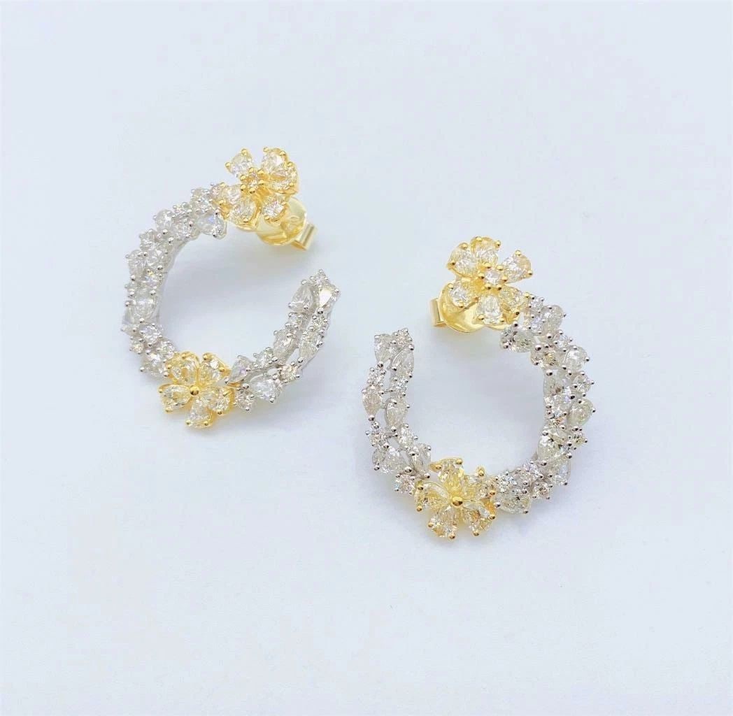 18KT GOLD FANCY 6.50CT DIAMOND FLOWER TWIST EARRINGS: 18KT GOLD FANCY 6.50CT DIAMOND FLOWER TWIST EARRINGS The Following Item we are offering is a Rare Important Radiant 18KT Gold Large Rare Fancy Diamond Flower Earrings. Earrings are comprised of Gorgeo