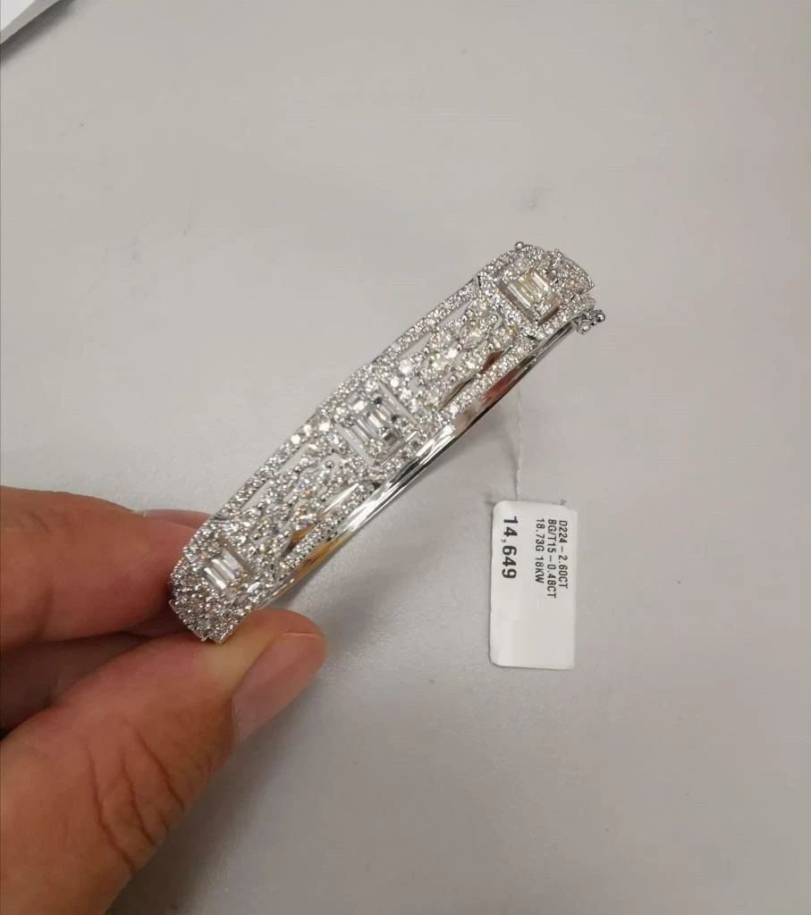 18KT GOLD IMPORTANT FANCY BAGUETTE DIAMOND BANGLE BRACELET: 18KT GOLD IMPORTANT FANCY BAGUETTE DIAMOND BANGLE BRACELET The Following Item we are offering is this Beautiful Rare Important 18KT White Gold Glittering Diamond Bangle Bracelet. Bracelet is comprised