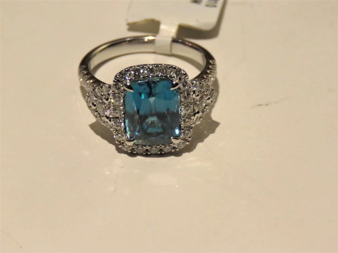 18KT GOLD LARGE BLUE ZIRCON DIAMOND RING: 18KT GOLD LARGE BLUE ZIRCON DIAMOND RING The Following Item we are offering is this Rare IMPORTANT SPECTACULAR 18KT GOLD LADY'S FULL CUT BRILLIANT LARGE EMERALD CUT BLUE ZIRCON DIAMOND RING. RING IS M