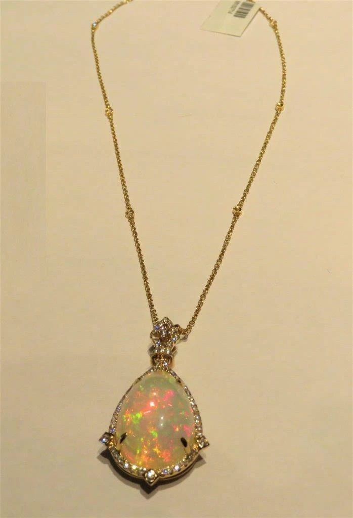 18KT RARE LRG FIERY WHITE OPAL DIAMOND PENDANT: 18KT RARE LRG FIERY WHITE OPAL DIAMOND PENDANT 18KT RARE LRG FIERY WHITE OPAL DIAMOND PENDANT The Following Items we are offering is a Rare Important Radiant 18KT Gold Large Fancy Fiery White Opal Dia