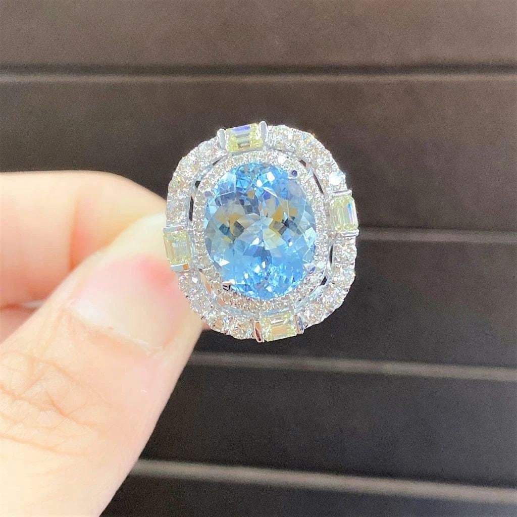 18KT GOLD GORGEOUS LARGE 7CT FANCY AQUAMARINE DIAMOND RING: 18KT GOLD GORGEOUS LARGE 7CT FANCY AQUAMARINE DIAMOND RING The Following Item we are offering is a Rare Important Radiant 18KT Gold Large Rare Fancy Gorgeous Large Oval Cut Aquamarine Diamond Ring. Ri