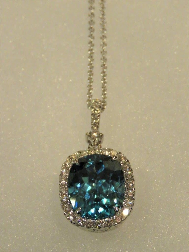 18KT GOLD LARGE 7CT BLUE ZIRCON DIAMOND PENDANT NECKLACE: 18KT GOLD LARGE 7CT BLUE ZIRCON DIAMOND PENDANT NECKLACE The Following Item we are offering is this Rare IMPORTANT SPECTACULAR 18KT GOLD LADY'S BRILLIANT LARGE OVAL CUSHION CUT BLUE ZIRCON DIAMOND PEN