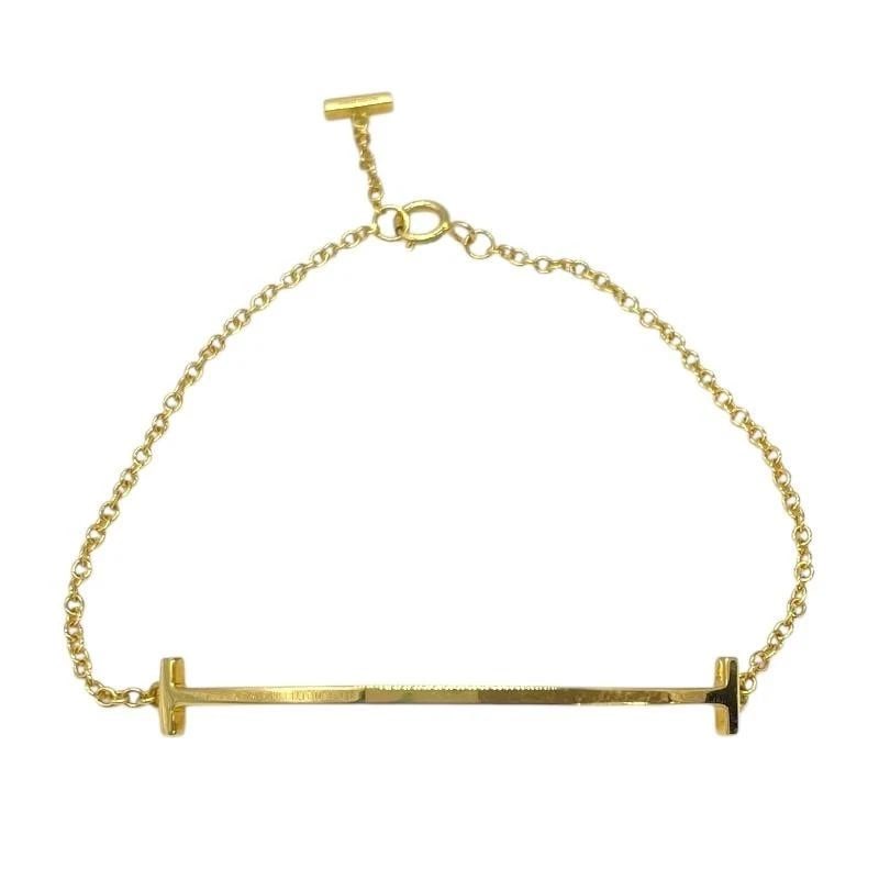 TIFFANY & CO. T SMILE 750 GOLD LENGTH 17CM LADIES BRACELET PRE OWNED: TIFFANY & CO. T SMILE 750 GOLD LENGTH 17CM LADIES BRACELET PRE OWNED Item Description Brand TIFFANY & CO.Product name T Smile Braceletmaterial Au750color goldsubject Women'ssize Length: Approx. 5.6mmW