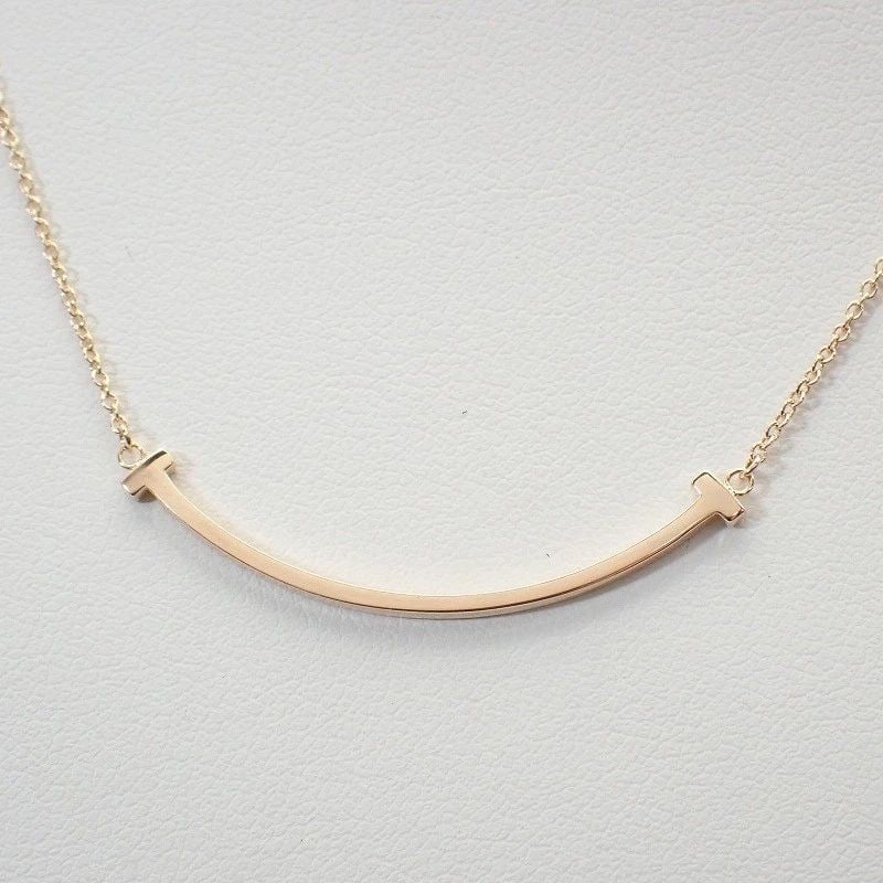 TIFFANY&CO. 750 K18PG T SMILE PENDANT SMALL NECKLACE PINK GOLD 40.5/45.5CM Y1006: TIFFANY&CO. 750 K18PG T SMILE PENDANT SMALL NECKLACE PINK GOLD 40.5/45.5CM Y1006 Item Description Product Name/Model Number: Tiffany & Co. 750 (K18PG) T Smile Pendant (Small)NecklaceCondition: ABMater