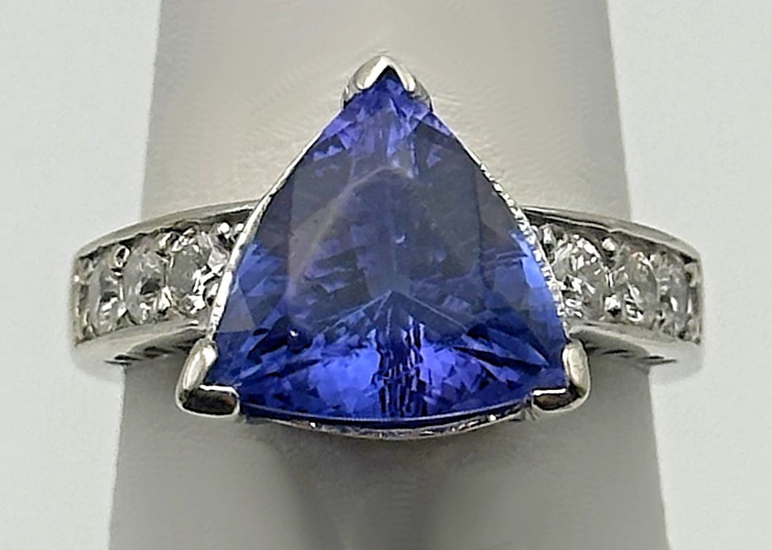 14K WHITE GOLD RING WITH 5.1CT TANZANITE AND 0.60CTS OF DIAMONDS SIZE: 6.75: 14k White Gold Ring with 5.1ct Tanzanite and 0.60cts of Diamonds Condition: Used, has been fully cleaned by our in house Jewelers, Tanzanite has some abrasions along the facet junctions of the table o