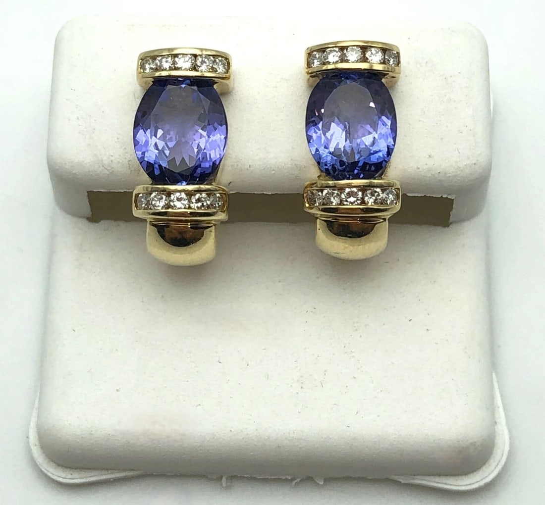 14K GOLD EARRINGS WITH 3.6CTS TANZANITES AND 0.40CTS OF DIAMONDS 7.6 GRAMS: 14k Gold Earrings with Tanzanite and 0.40cts of Diamonds Condition: Used Material: 14k Yellow Gold Weight: 7.6 grams Earrings Size: 16mm x 7.4mm Back Type: Omega Backs Stone Info: The Tanzanite
