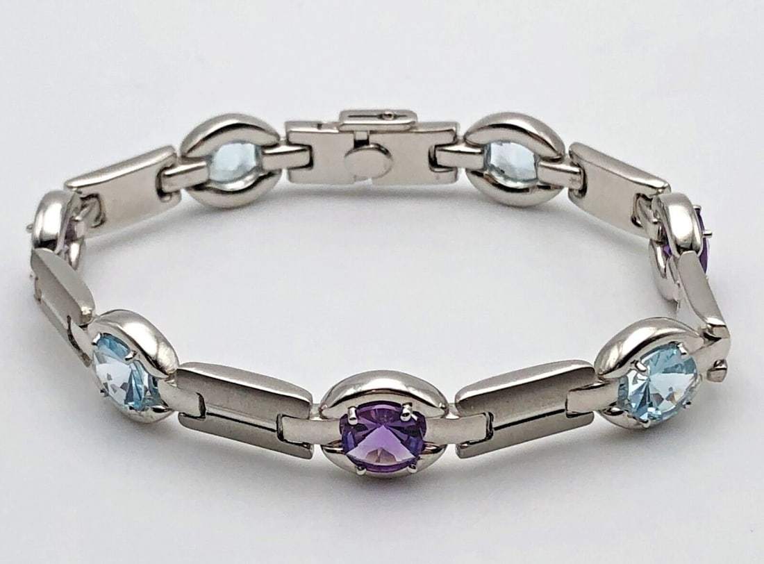 14K WHITE GOLD TNT LINKED BRACELET W/ BLUE TOPAZ AND AMETHYST (7.5") 17.1GRAMS: 14K WHITE GOLD TNT LINKED BRACELET SET WITH BLUE TOPAZ AND AMETHYST 7.5" 14k White Gold TNT Linked Bracelet set with Blue Topaz and Amethyst Condition: Used Material: 14k White Gold. Made in Italy. Br