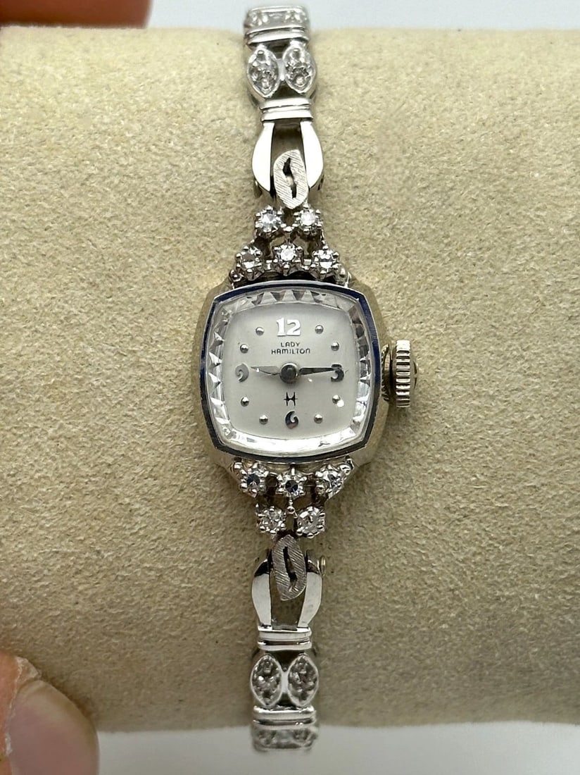 LADY HAMILTON 14K WHITE GOLD WATCH WITH 0.42CTS OF DIAMONDS 15.4 GRAMS TOTAL: Lady Hamilton 14k White Gold Watch with 0.42cts of Diamonds Condition: Used, runs & keeps time Material: 14k White Gold for case and band. The case and band weighs 12.1 grams without the movement insi