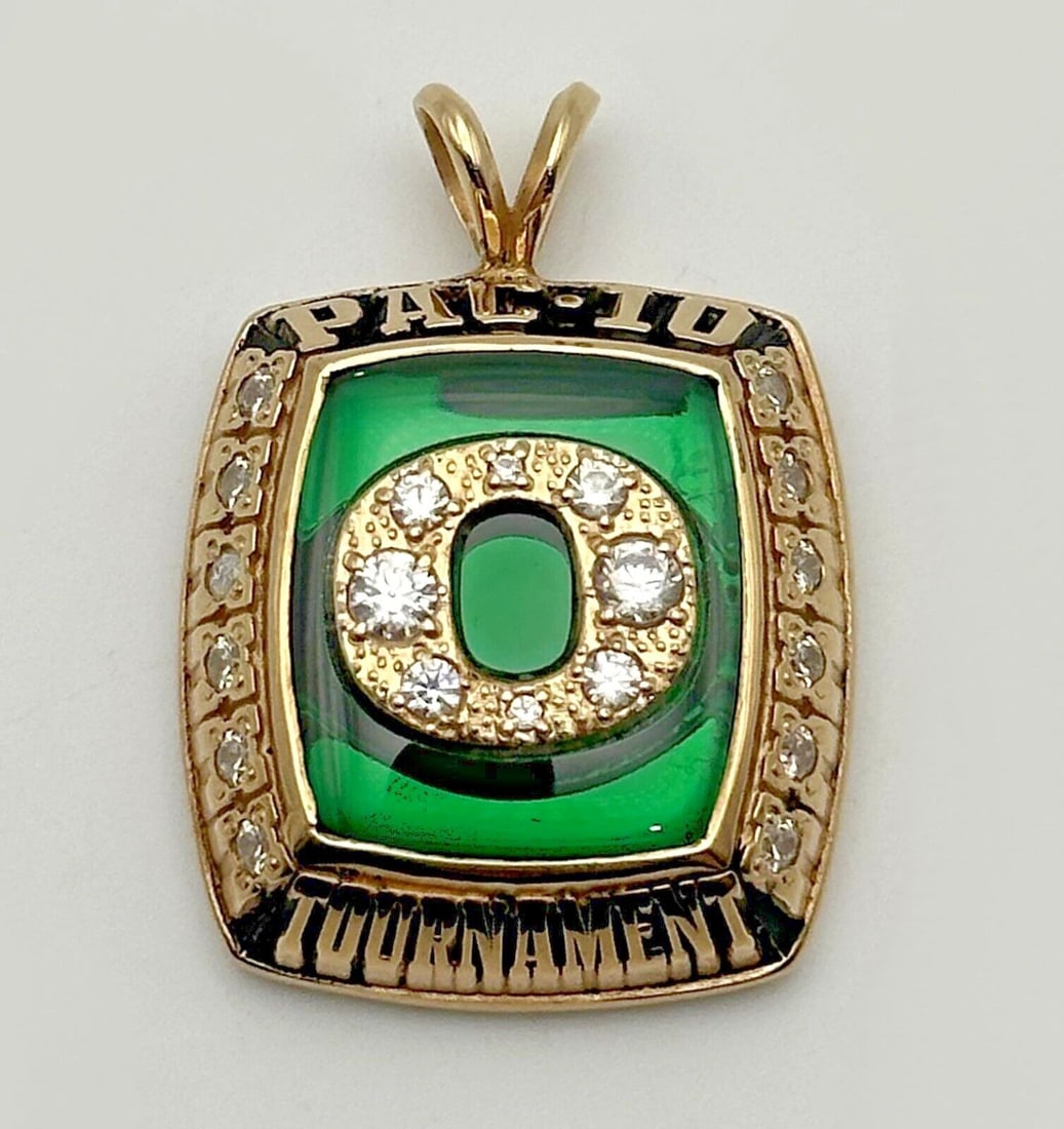 PAC-10 TOURNAMENT 10K YELLOW GOLD JOSTENS PENDANT 12.5 GRAMS: PAC-10 Tournament 10k Yellow Gold Jostens Pendant Condition: Used Material: 10k Yellow Gold Pendant Size: 21mm x 8mm Total Weight: 12.5 grams Stone Info: The green portion is just a plastic enameling.