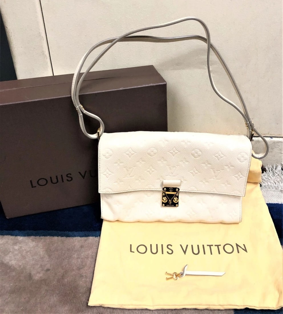 LOUIS VUITTON CREME HAND BAG WITH BUTTON CLIP STRAP AND FRONT LOCK WITH KEY (1 of 2)
