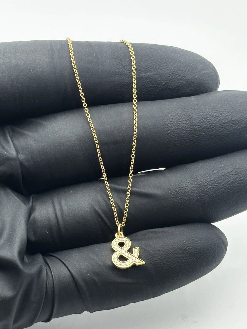 TIFFANY & CO. 18K GOLD NECKLACE, 0.70CTW DIAMOND AMPERSAND PENDANT 18" 2.5G: Tiffany & Co. 18k Gold Necklace, 0.7ct Diamond Ampersand Pendant Condition: Used, has been worn and moved around in inventory Material: 750 / 18k Yellow Gold Necklace Size: Has two points of connectio