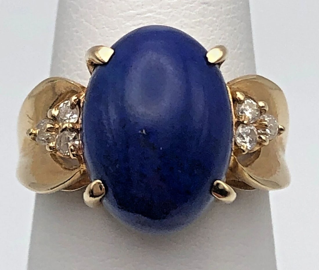 14K GOLD RING WITH BLUE LAPIS AND 0.12CTS OF DIAMONDS SIZE: 6.5 5.7G: 14k Gold Ring set with center Blue Lapis and 0.12cts of Diamonds Condition: Used Material: 14k Yellow Gold Ring Size: 6.5 Weight: 5.7 grams Top Width: 14mm Bottom Width: 2.6mm Stone Info: Center stone