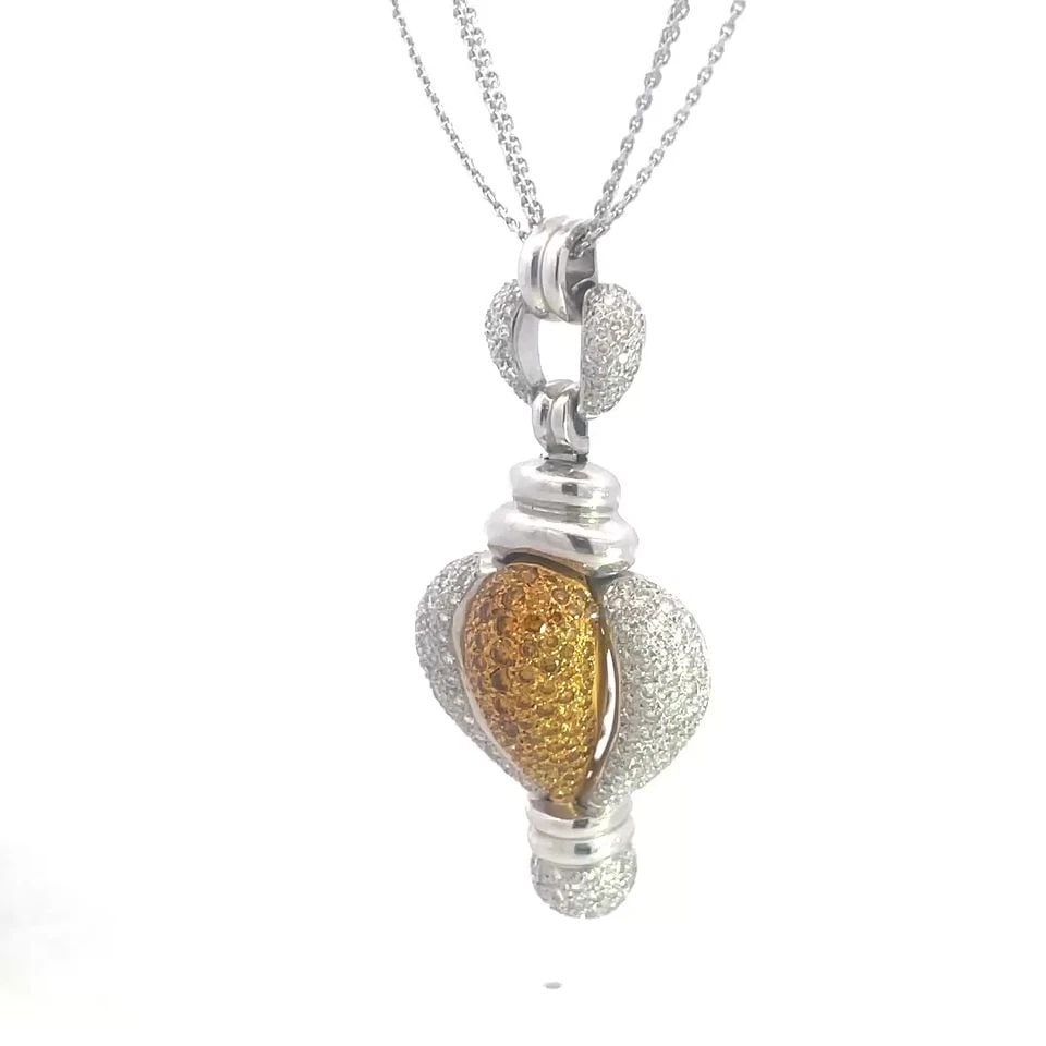 DIAMONDS GOLD PUFFED PENDANT ALL NATURAL 18K TWO TONE TRIPLE CHAIN NECKLACE: This eye-catching pendant and triple chain necklace is a stunning 18k white and yellow gold featuring a puffed pendant almost a heart like dome shape, yellow in the center with yellow diamonds and whi