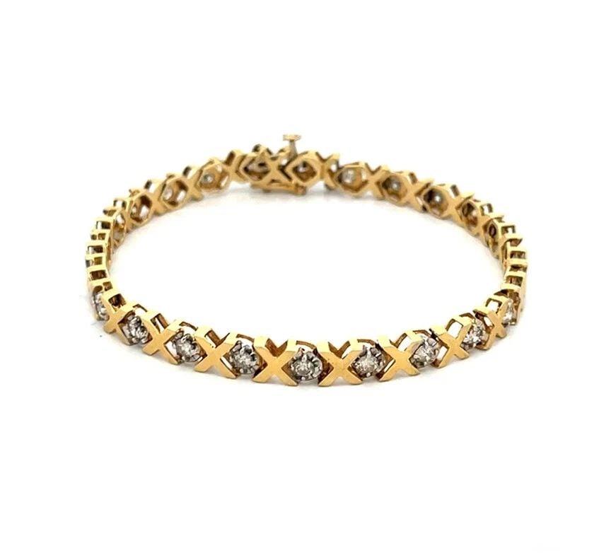 DIAMOND GOLD BRACELET 14K YELLOW X LINK WHITE GOLD PRONG SET: Add this elegant bracelet to your collection, a timeless piece crafted in 14k yellow gold, adorned with a series of sparkling white diamonds. Each diamond, prong-set in white gold mount, it radiates a