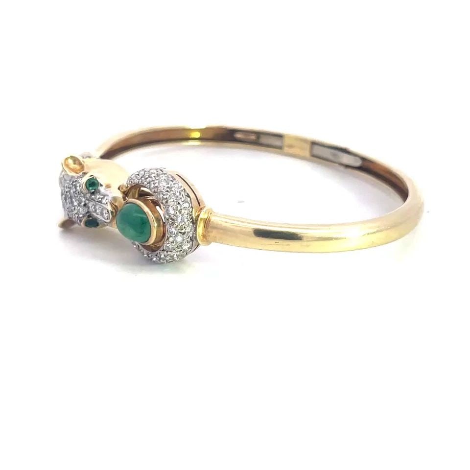 DIAMOND GOLD GEM PANTHER BANGLE 14K TWO TONE DOORKNOCKER STYLE: DIAMOND GOLD GEM PANTHER BANGLE 14K TWO TONE DOORKNOCKER STYLE This lovely flex hinged bracelet is crafted from 14k yellow gold with white gold accent. It features the hinged mechanism on the band of 