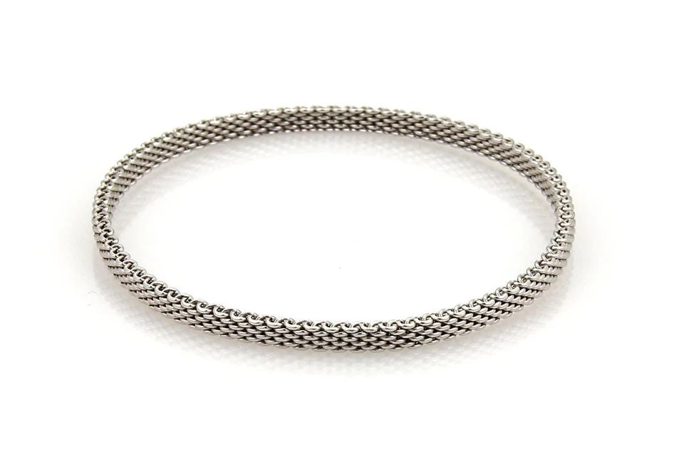 TIFFANY & CO. SOMERSET BRACELET 18K WHITE GOLD WIDE MESH BANGLE: TIFFANY & CO. SOMERSET BRACELET 18K WHITE GOLD WIDE MESH BANGLE Tiffany & Co. Somerset 18k White Gold 4mm Wide Mesh Bangle Bracelet Description This is an elegant authentic bangle by Tiffany & Co. fro