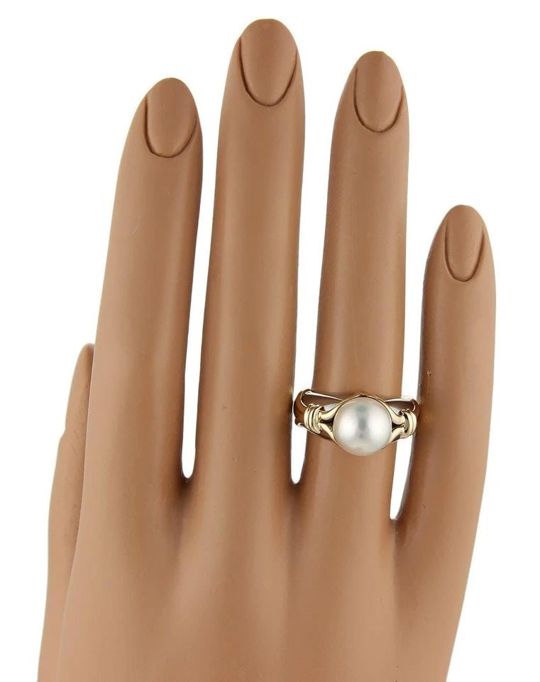 BULGARI PEARL GOLD RING 18K YELLOW & WHITE FANCY DOME SHANK: BULGARI PEARL GOLD RING 18K YELLOW & WHITE FANCY DOME SHANK This lovely ring is by Bulgari; it is a luxurious piece of fine jewelry featuring a stunning Akoya pearl set in 18k yellow and white multi-t