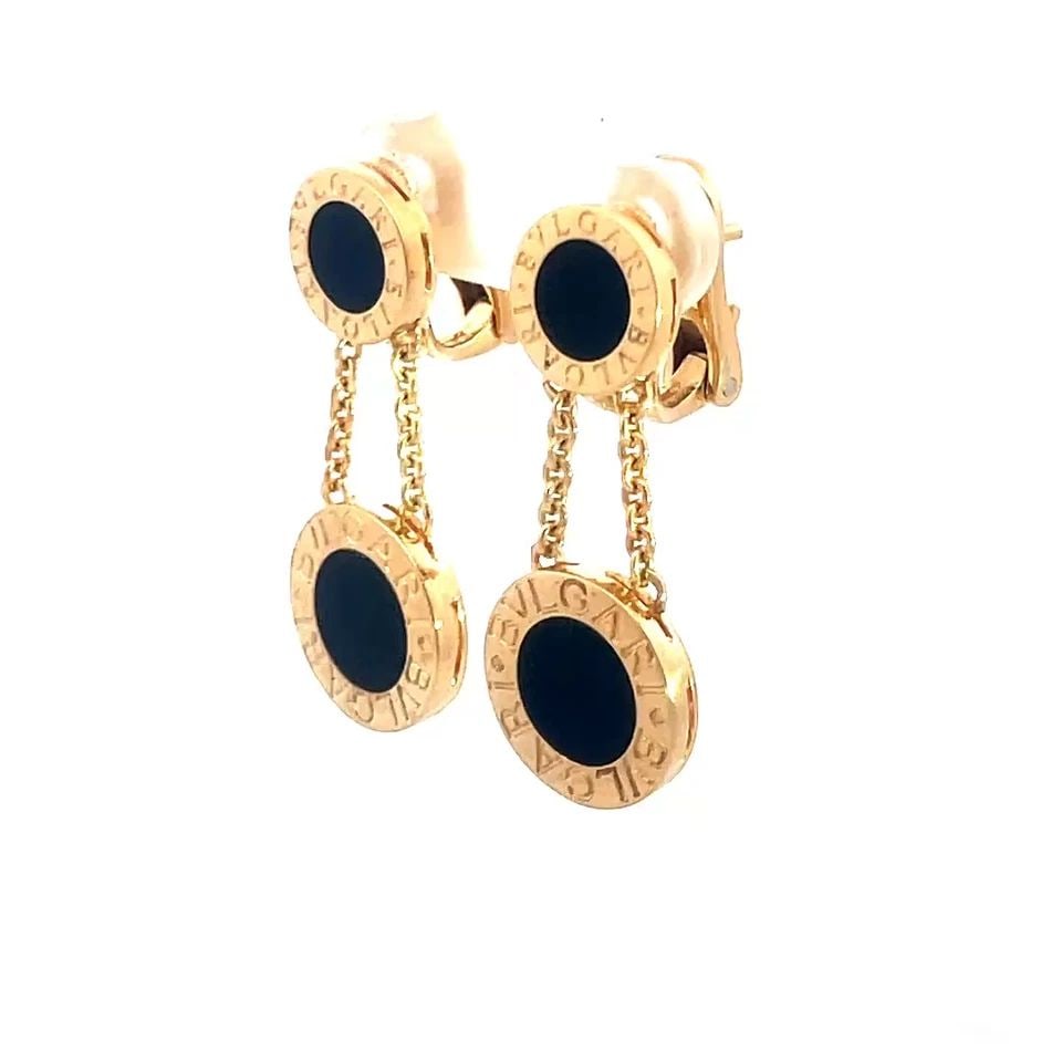 70802 BVLGARI ONYX GOLD EARRINGS ENGRAVED 2 DISC 18K YELLOW DANGLE STYLE: 70802 BVLGARI ONYX GOLD EARRINGS ENGRAVED 2 DISC 18K YELLOW DANGLE STYLE These lovely pair of earrings are by Bvlgari, crafted from 18k yellow gold featuring a round disc at the top round onyx stone i