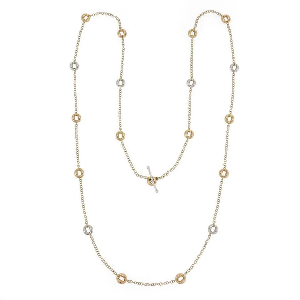 ROBERTO COIN NECKLACE 18K TWO TONE GOLD "O" MOTIFS 35" LONG: ROBERTO COIN NECKLACE 18K TWO TONE GOLD "O" MOTIFS 35" LONG The Roberto Coin Necklace is a luxurious piece of fine jewelry made from 18k two-tone gold. It features a unique "O" motif design along its 