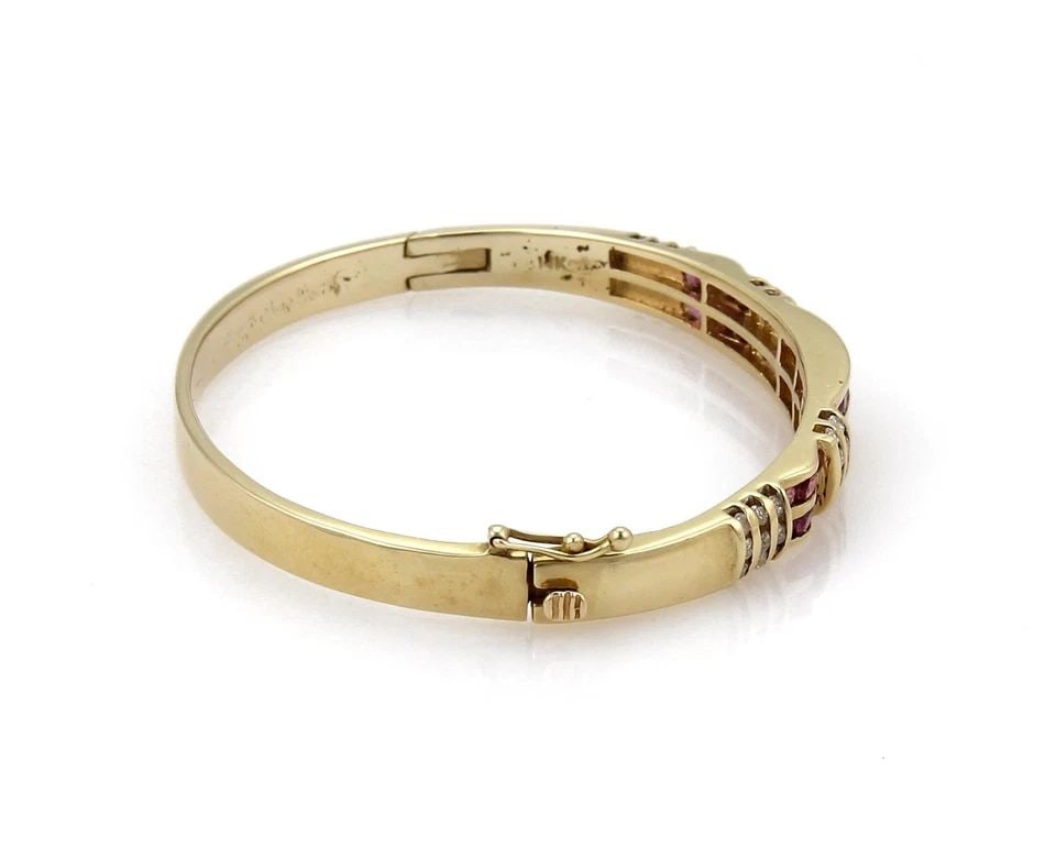 DIAMOND BRACELET & RED GEMSTONE 14K YELLOW GOLD: DIAMOND BRACELET & RED GEMSTONE 14K YELLOW GOLD This Diamond Bracelet is set in 14k Yellow Gold and features stunning round natural diamonds as the main stones. The bangle style adds a touch of elegan