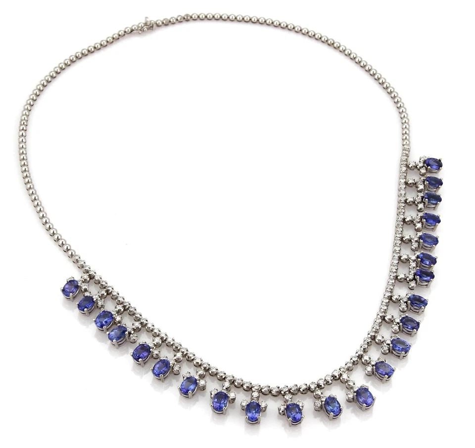 DIAMOND GOLD NECKLACE TANZANITE 18K WHITE BIB STYLE: DIAMOND GOLD NECKLACE TANZANITE 18K WHITE BIB STYLE The Diamond & Tanzanite Gold Necklace is a stunning piece of fine jewelry featuring a white diamond with a very good cut grade set in 18k white gold