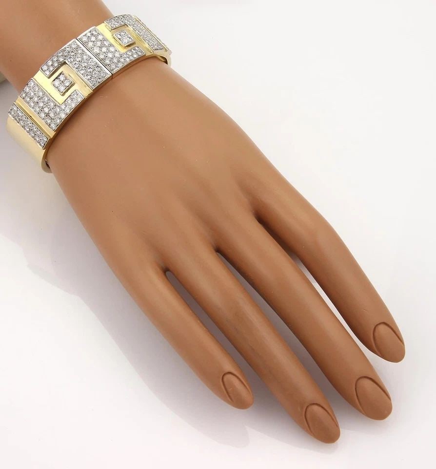 DIAMOND GOLD BRACELET 18K TWO TONE HEAVY WIDE FLEX OPEN BAND 73GRAMS: DIAMOND GOLD BRACELET 18K TWO TONE HEAVY WIDE FLEX OPEN BAND 73GRAMS This Diamond 18k yellow gold flex open bracelet features a natural round diamonds set in 18k white gold. The bracelet has a length 