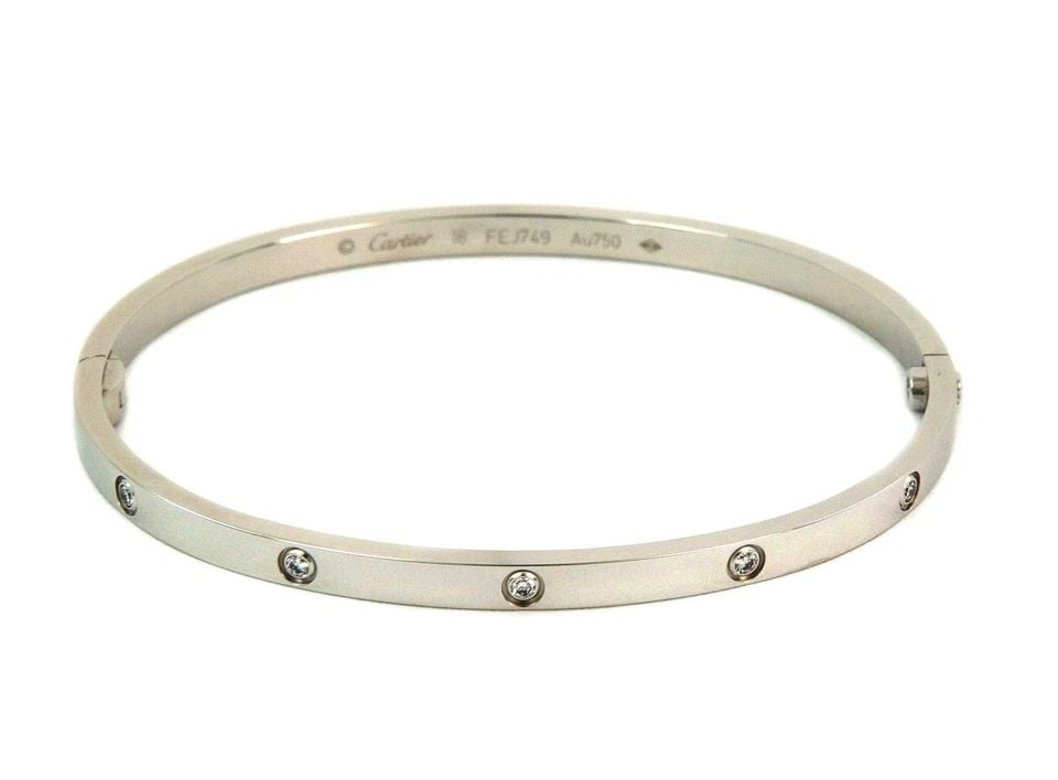 CARTIER LOVE DIAMOND 18K W/G SMALL MODEL BANGLE SIZE 18 W/SCREWDRIVER & PAPER: CARTIER LOVE DIAMOND 18K W/G SMALL MODEL BANGLE SIZE 18 W/SCREWDRIVER & PAPER Cartier Love Diamond 18k W/G Small Model Bangle Size 18 w/Screwdriver & Paper Description This is the iconic authentic bra
