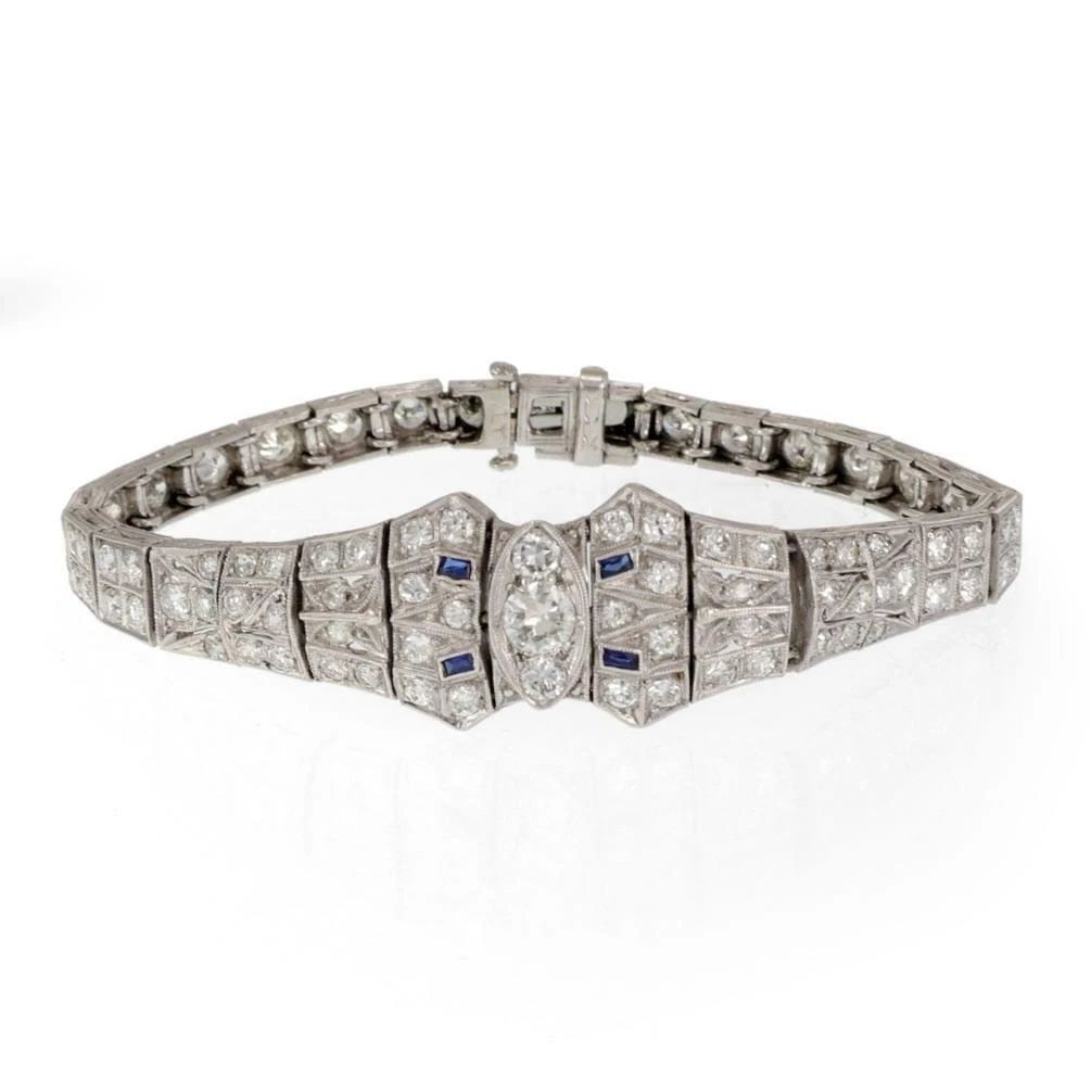 DIAMOND PLATINUM BRACELET TAPERED MILGRAIN DESIGN ART DECO: DIAMOND PLATINUM BRACELET TAPERED MILGRAIN DESIGN ART DECO This Diamond Platinum Bracelet features a tapered milgrain design in an Art Deco style. The vintage piece is adorned with blue gemstones and 
