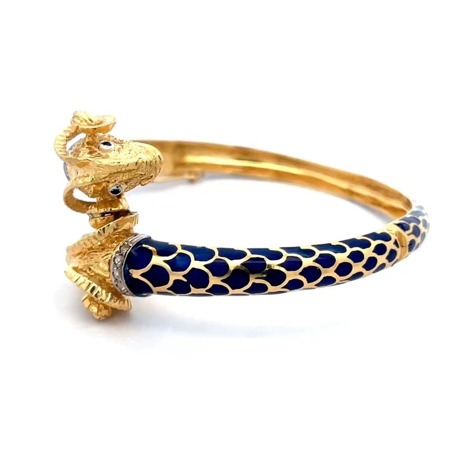 GOLD RAMS HEAD BRACELET DOUBLE HEAD 18K YELLOW HINGE BANGLE BLUE ENAMEL VINTAGE: GOLD RAMS HEAD BRACELET DOUBLE HEAD 18K YELLOW HINGE BANGLE BLUE ENAMEL VINTAGE This is an impressive vintage and detailed sculpted bypass bracelet; it is crafted from 18k yellow gold featuring a doub