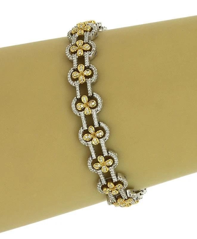DIAMOND GOLD BRACELET 18K TWO TONE FLORAL LINK STYLE: DIAMOND GOLD BRACELET 18K TWO TONE FLORAL LINK STYLE This is a gorgeous two tone 18k gold and diamonds ladies ornate dress bracelet. The piece is well crafted in 18k white gold with a smooth, polished