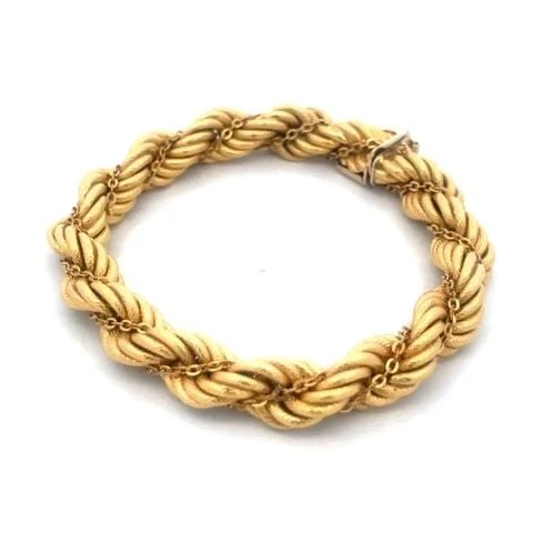 18K LADIES ROPE BRACELET WITH TWISTED CHAIN: 18K LADIES ROPE BRACELET WITH TWISTED CHAIN This lovely rope bracelet is crafted from 18k yellow gold featuring a textured twisted design with an oval link chain wrapped around the rope twist. The bra
