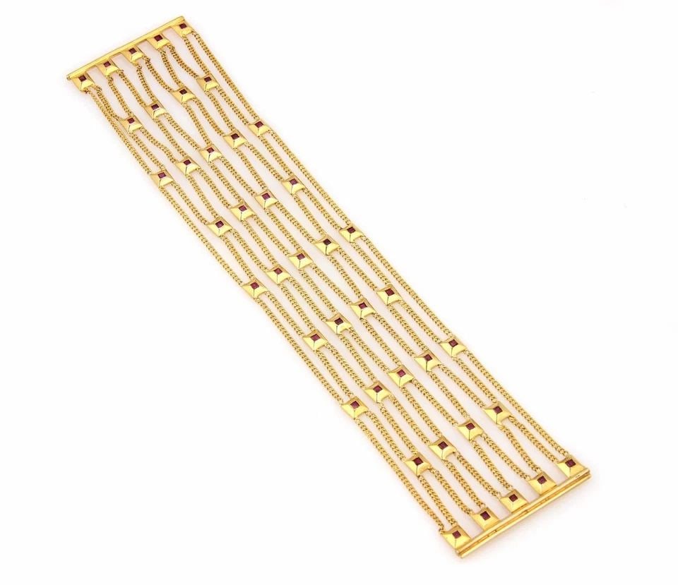 GOLD RUBY BRACELET 18K YELLOW WIDE 10 STRAND SQUARE MOTIFS FLEX STYLE: GOLD RUBY BRACELET 18K YELLOW WIDE 10 STRAND SQUARE MOTIFS FLEX STYLE This is a gorgeous eye-catching gold bracelet, featuring 10 strands of curb link chain with square-shaped motifs and bezel set rub