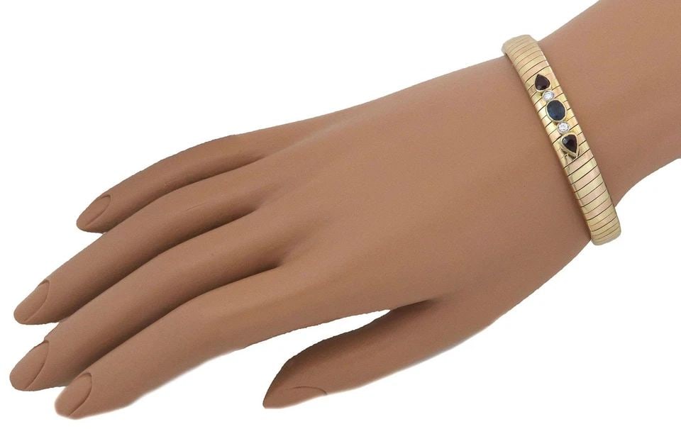 DIAMOND RUBY SAPPHIRE BRACELET 18K ROSE YELLOW GOLD TUBOGAS FLEX CUFF: DIAMOND RUBY SAPPHIRE BRACELET 18K ROSE YELLOW GOLD TUBOGAS FLEX CUFF Diamond Ruby Sapphire18k Rose Yellow Gold Tubogas Flex Cuff Bracelet Description This is an elegant tapered shape flex cuff bracel