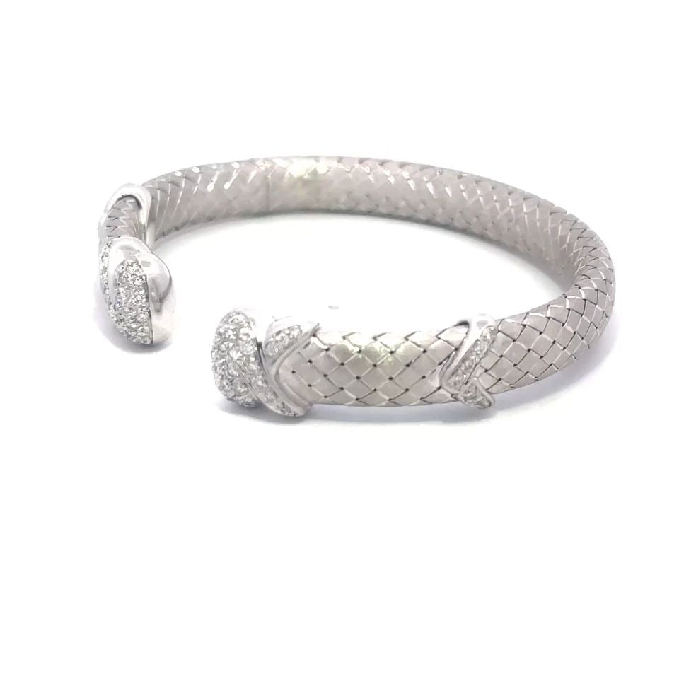 DIAMOND GOLD CUFF BRACELET 18K WHITE PAVE SET BASKET WEAVE STYLE ARIMAR: DIAMOND GOLD CUFF BRACELET 18K WHITE PAVE SET BASKET WEAVE STYLE ARIMAR The Diamond Gold Cuff Bracelet signed Arimar is a stunning piece of fine jewelry crafted from 18k white gold. The bracelet featu