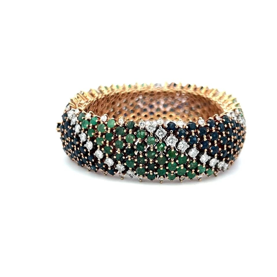 SAPPHIRE, EMERALD & DIAMOND 18K YELLOW GOLD MULTI-ROW LINK BRACELET: SAPPHIRE, EMERALD & DIAMOND 18K YELLOW GOLD MULTI-ROW LINK BRACELET Title: This exceptional multi-row bracelet showcases a vibrant mosaic of natural sapphires, emeralds, and brilliant-cut diamonds met