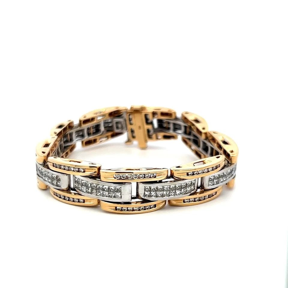 14 KARAT TWO-TONE GOLD LINK BRACELET WITH 6.26 CARAT ROUND AND PEAR DIAMONDS: 14 KARAT TWO-TONE GOLD LINK BRACELET WITH 6.26 CARAT ROUND AND PEAR DIAMONDS Detailed Description: Elevate your style with this vintage two-tone gold bracelet, intricately designed with a stunning arr
