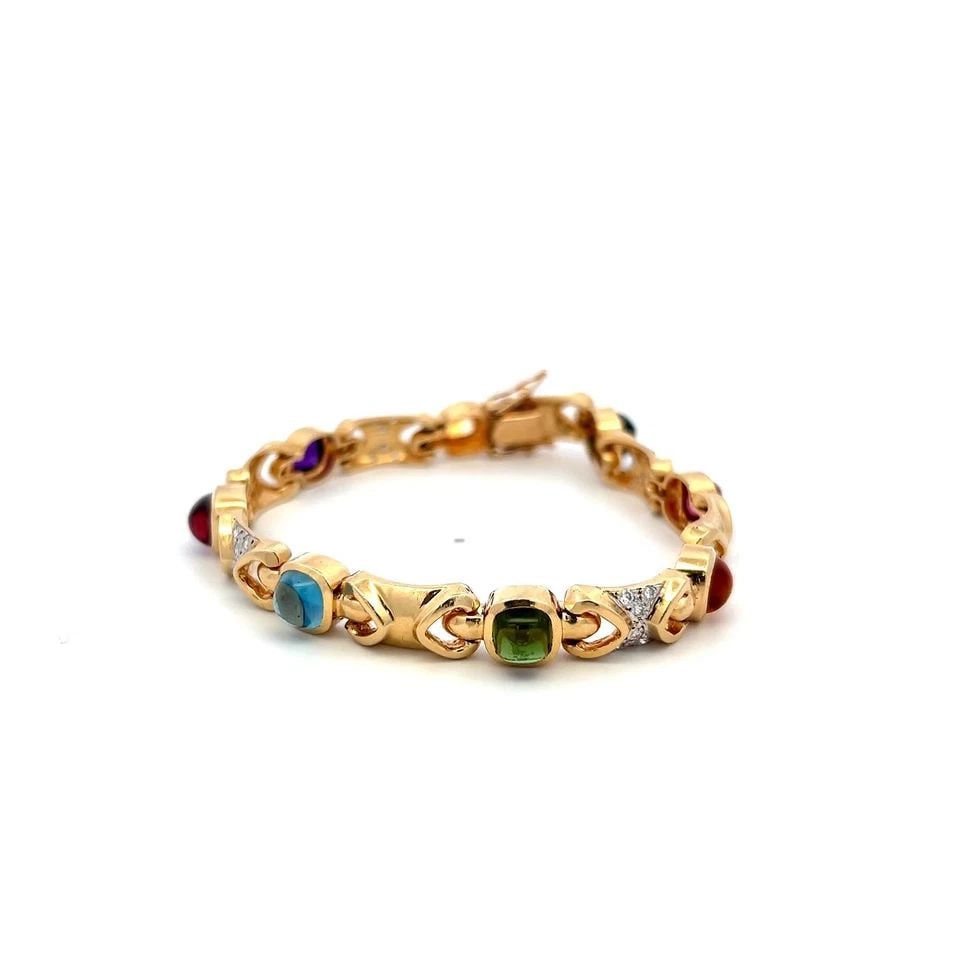 14K YG LINK BRACELET WITH 0.48 CARAT ROUND G-SI DIAMONDS & MULTI-GEMSTONES: 14K YG LINK BRACELET WITH 0.48 CARAT ROUND G-SI DIAMONDS & MULTI-GEMSTONES Video: Video Link Detailed Description: This vintage bracelet showcases a luxurious blend of 14 karat yellow gold and an arra