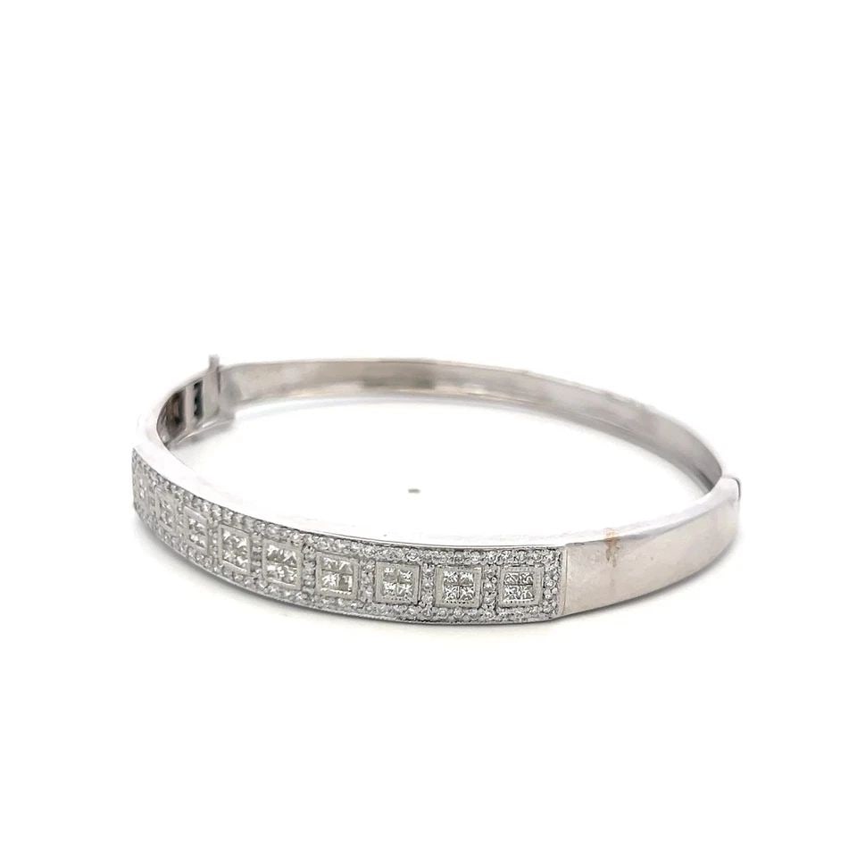 14K WHITE GOLD BANGLE BRACELET WITH 1.42 CARAT ROUND AND PRINCESS CUT DIAMONDS: 14K WHITE GOLD BANGLE BRACELET WITH 1.42 CARAT ROUND AND PRINCESS CUT DIAMONDS Detailed Description: Elevate your elegance with this vintage 14K white gold bangle, featuring a stunning combination of 