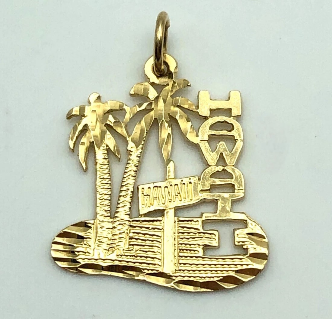 14K YELLOW GOLD HAWAII PENDANT 1.3 GRAMS: 14k Yellow Gold HAWAII Pendant Condition: Used Material: 14k Yellow Gold Pendant Size: 24mm x 18mm x 0.6mm Total Weight: 1.3 grams Bail Info: Fits a size 3mm wide necklace
